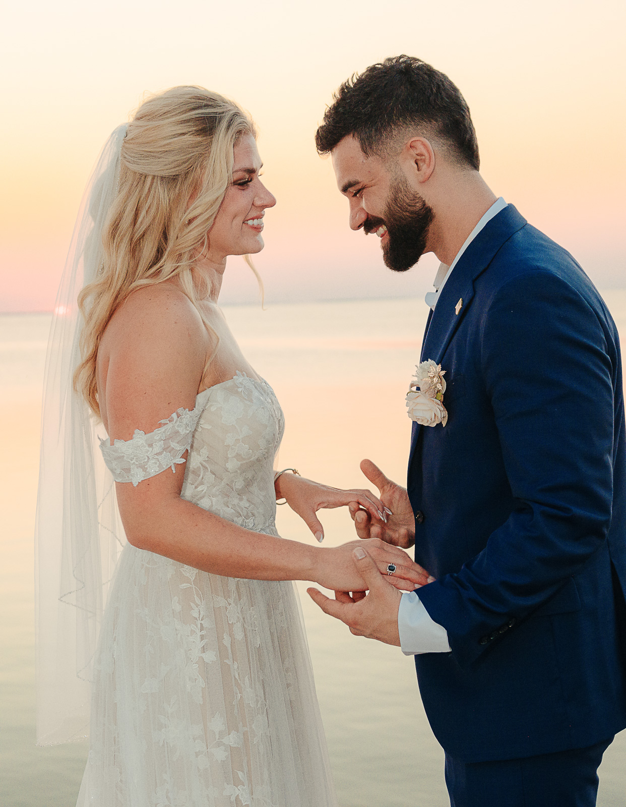 Bride and groom exchanging rings at golden sunset — Texas wedding ceremony